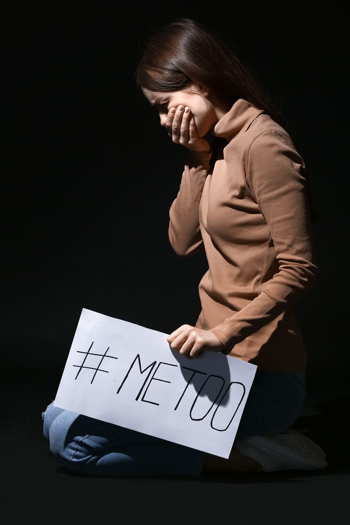 Young Woman Holding Paper with Hashtag MeToo on Dark Background